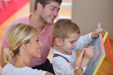 Family drawing on school board at home
