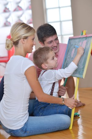 family drawing on school board at home