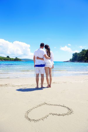 Couple and heart on sand