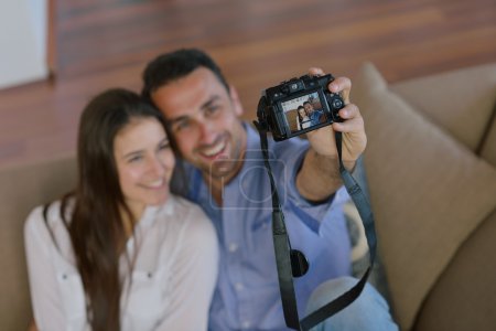 Couple playing with digital camera