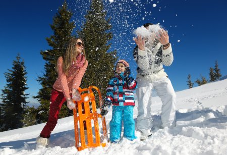 Family playing on fresh snow