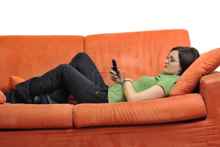 happy young woman relax on orange sofa
