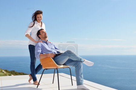 Couple at balcony with computer