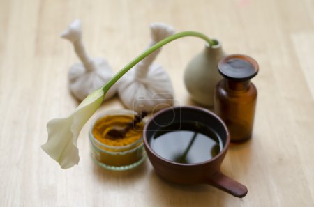 An arrangement of spice, oil and massaging tools used in Ayurved