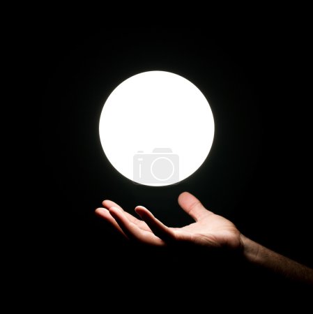 Light ball over human hand