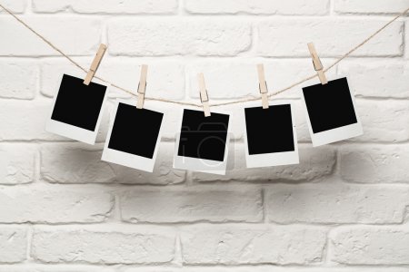 Blank photos hanging on a clothes line