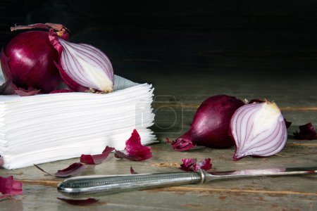 Red onions on a pile of paper tissues