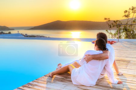 Couple in hug watching together sunrise