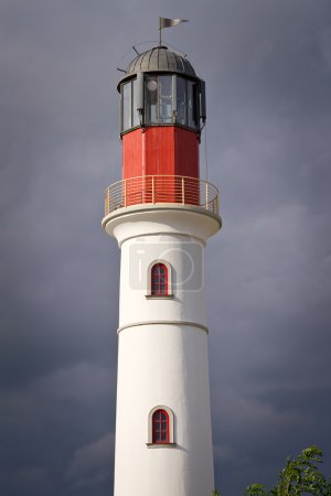 White lighthouse over dramatic sky