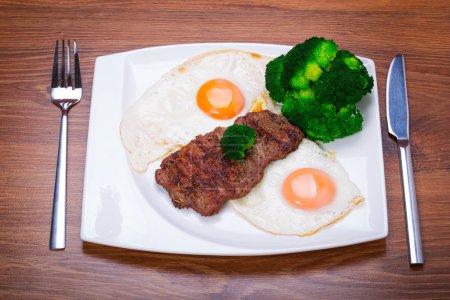 Grilled beef steak with eggs
