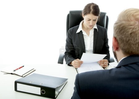 beard business man brunette woman at desk read contract