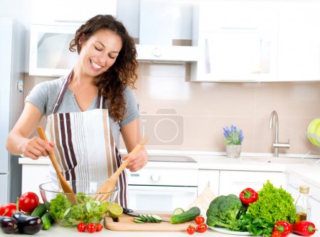 Young Woman Cooking. Healthy Food - Vegetable Salad
