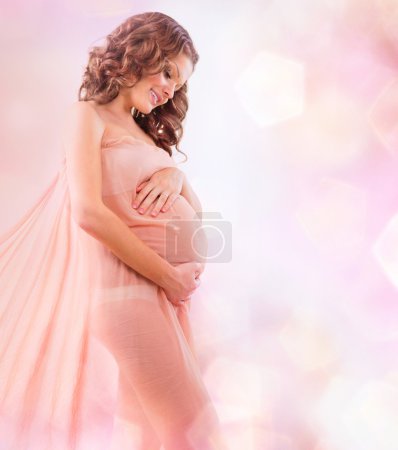 Beauty Pregnant Woman in Blowing Pink Chiffon Shawl
