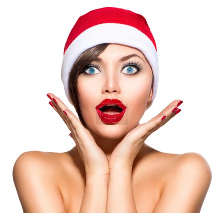 Christmas Woman. Beauty Model Girl in Santa Hat over White