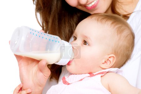 Feeding Baby. Baby eating milk from the bottle