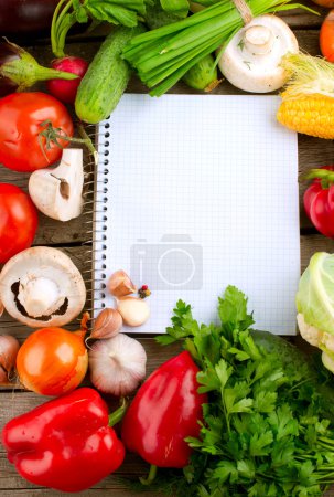 Open Notebook and Fresh Vegetables Background. Diet