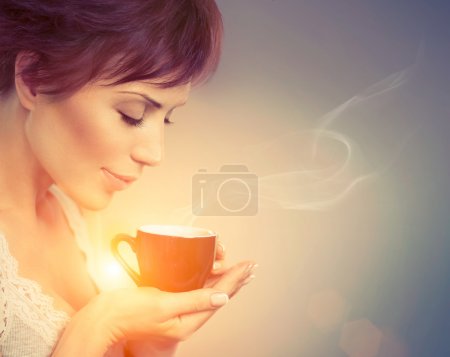 Beautiful Girl Enjoying Coffee. Woman with Cup of Hot Beverage