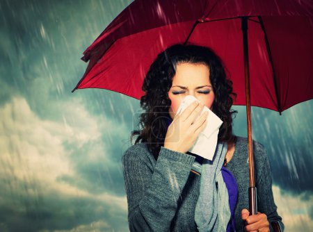 Sneezing Woman with Umbrella over Autumn Rain Background