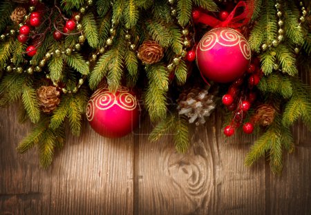 Christmas Tree and Decorations Over Wooden Background