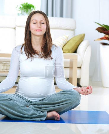 Beautiful Pregnant Woman Doing Yoga at Home