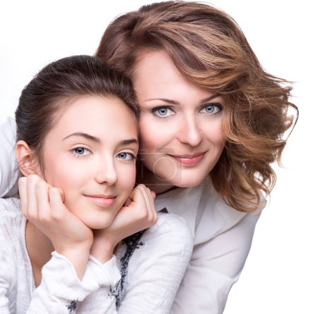 Mother and smiling teenage daughter