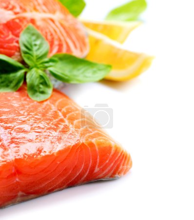 Raw Salmon Red Fish Steak with Herbs and Lemon isolated on White