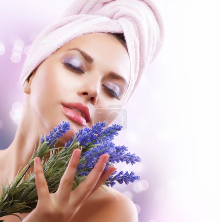 Spa Girl with Lavender Flowers. Beautiful Young Woman After Bath