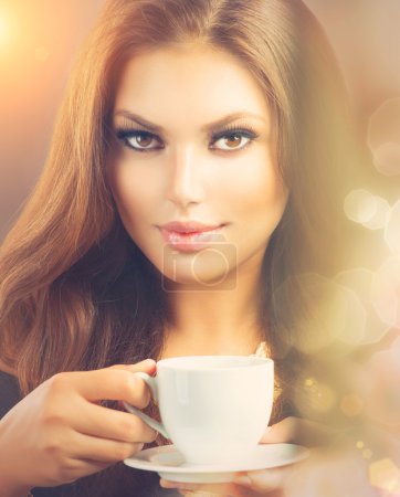Coffee. Beautiful Sexy Girl Drinking Tea or Coffee