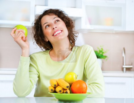 Dieting concept. Healthy Food. Young Woman Eats Fresh Fruit