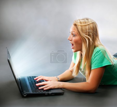 Surprised Girl With a Laptop. Working on Computer