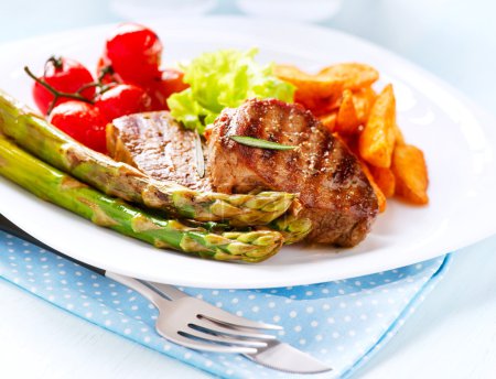 Grilled Beef Steak Meat with Fried Potato, Asparagus, Tomatoes