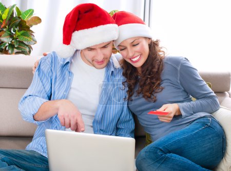 Christmas Online Shopping. Couple Using Credit Card to E-Shop