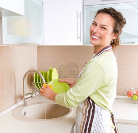Dishwashing. Happy Young Woman Washing Dishes