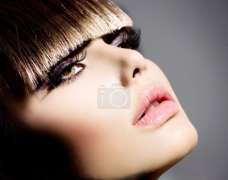 Fringe. Fashion Model Girl With Trendy Hairstyle and Makeup