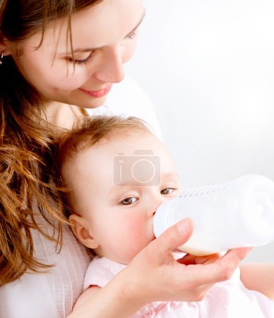 Feeding Baby. Baby eating milk from the bottle