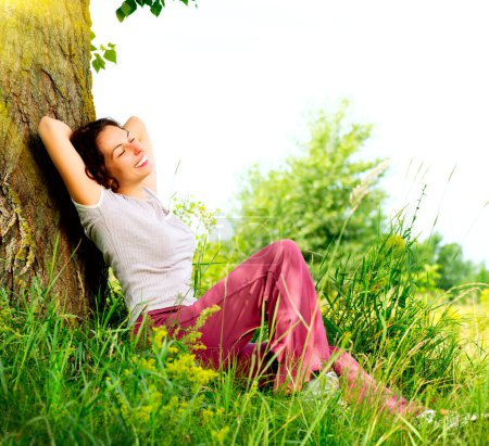 Beautiful Young Woman Relaxing outdoors. Nature