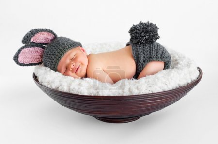 Newborn baby boy wearing bunny ears and a bunny tail