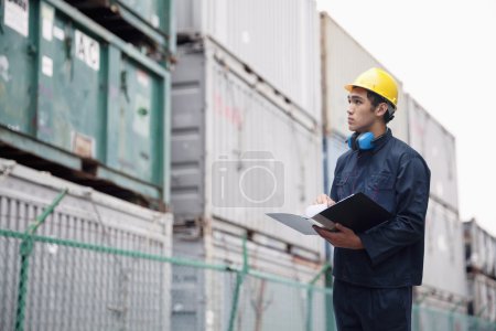 Worker examining cargo in a shipping yard