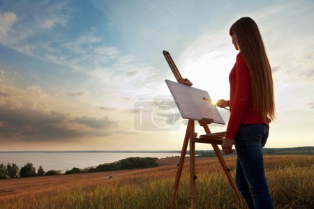 Artist painting an sea landscape