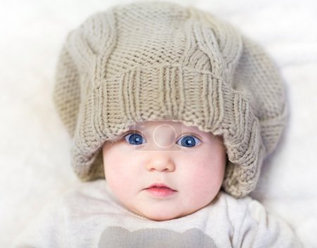 Newborn baby wearing a big knitted hat