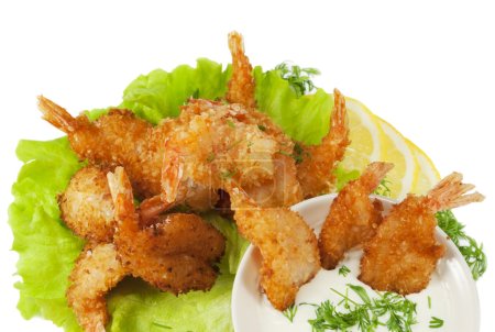 Fried prawns in coconut breading with dipping sauce on white iso