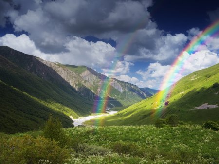 River and rainbow in the mountains