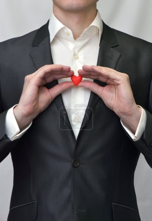 Guy holding a red heart
