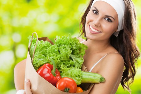 Woman in fitness wear with vegetarian food