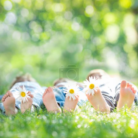 kids with daisy flowers on green grass