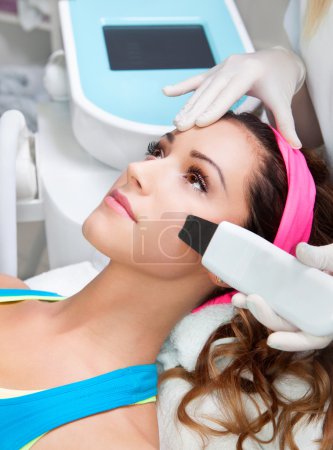 Woman getting laser face treatment