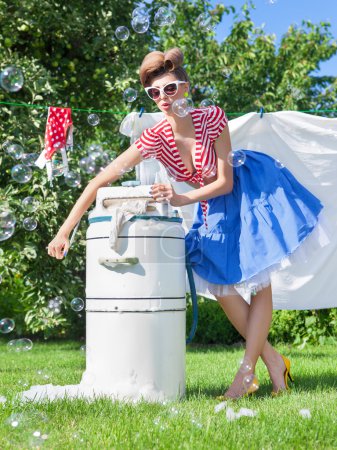 Woman with vintage wringer washing machine