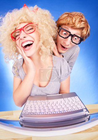 Funny couple using laptop computer