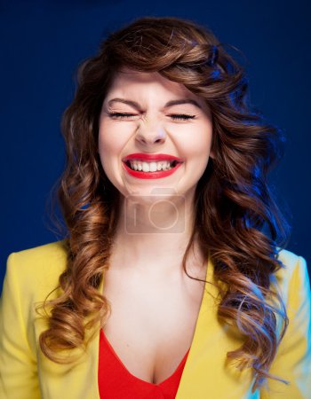 Portrait of an attractive young woman laughing hard