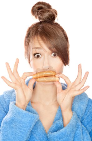 Woman with sausages simulating lip enhancement she's dreaming of filler injection